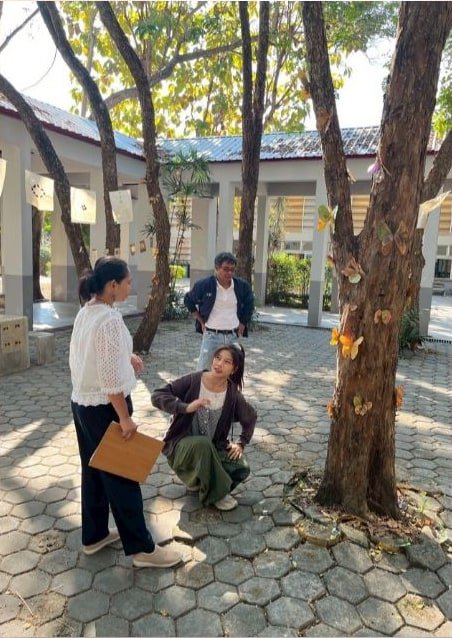 Site discussion beside the decorated tree.