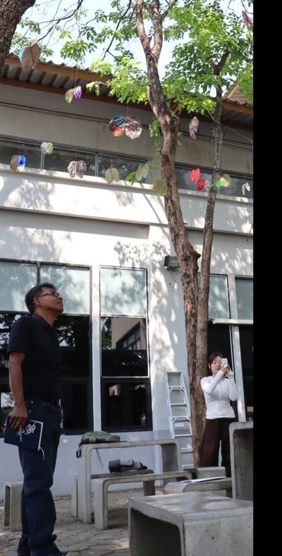 Viewer looking up at suspended leaf elements.